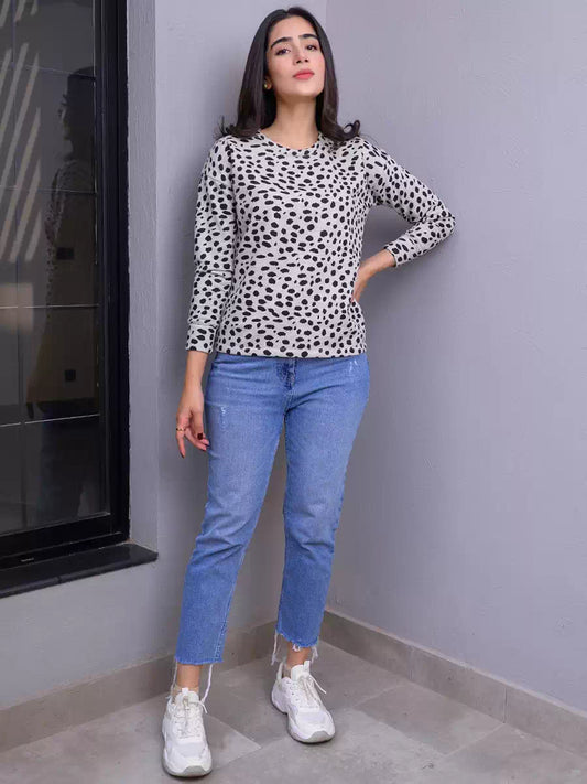 Full-length front view of the Heather Grey animal print sweatshirt, styled with blue jeans and white sneakers as the model stands with one hand on her hip.