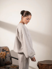 Side view of the Barlow Heather Grey sweatshirt highlighting its oversized body, dropped shoulders and balloon sleeve shape.