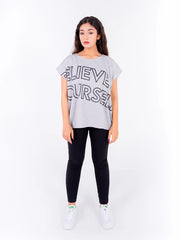 Full front view of Coastline's Believe In Yourself Top in Ash Grey, showing the oversized black typography print and straight, loose-fitting hem.