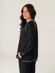 Side view of the Berlin Black matching set highlighting the longer-length top, relaxed silhouette and sleeve stitching.
