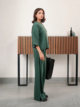 The Blair Evergreen double-knit co ord set with a relaxed top and matching wide-leg trousers, shown from the side