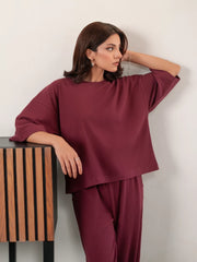 Model wearing The Blair Plum matching set with a relaxed-fit top and flowing wide-leg trousers