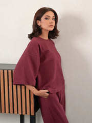 Three-quarter view of The Blair Plum co ord set with a relaxed top and matching wide-leg trousers