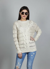 Model wearing Coastline's Ivory Cable Knit Sweater with blue distressed jeans, showing the front cable-knit pattern.