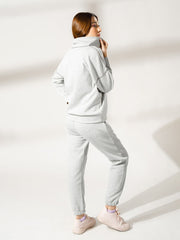 Back view of the Calca Heather Grey winter matching set showing the relaxed top silhouette and matching trousers.