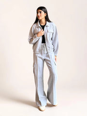 Model wearing Coastline’s heather gray fleece matching set with a collared zip-front jacket, chest pockets and wide-leg cargo trousers.