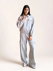 Full-length view of a model wearing Coastline’s heather gray co-ord set, showing the relaxed zip-front jacket and cargo trousers with thigh pockets.