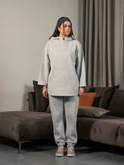 Full-length front view of the Darya Heather Grey winter co-ord set, with the model raising one hand near her hair.