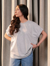Model wearing Coastline's Elle Top in Heather Grey, showing its relaxed oversized fit and soft cotton jersey fabric.