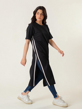 Model wearing Coastline's Eve Side Slit Maxi Dress in Black, featuring contrast tape detailing and a long side slit.