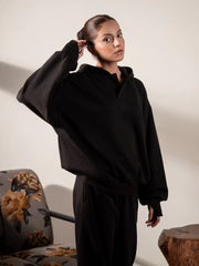 Three-quarter view of the Garconne Black hoodie and trouser set, showing its relaxed silhouette and double-layer hood.