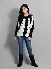 Model wearing Coastline's Kate Fuzzy Sweater in Black and White, styled with blue jeans and black boots.