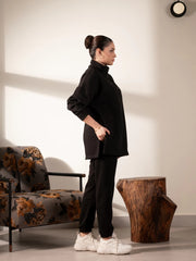 Side view of the Nina Black matching set showing the longer-length sweatshirt and matching black trousers