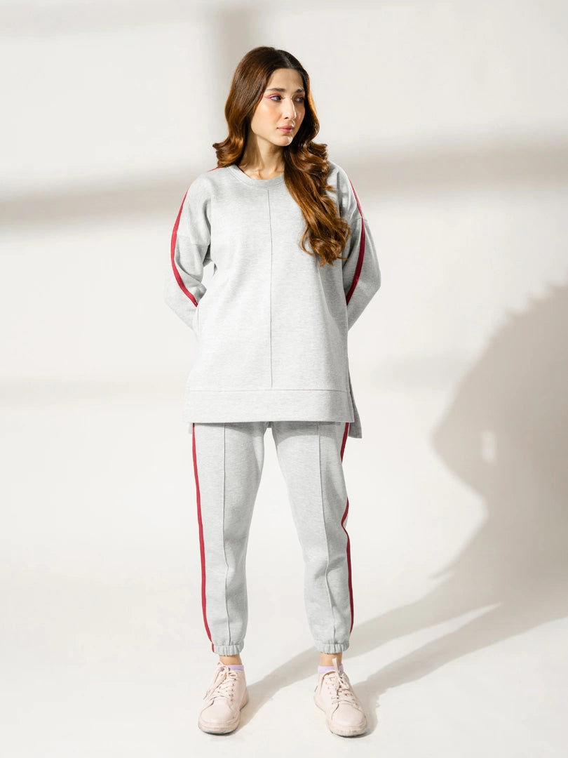 Full-length view of Ora Heather Grey winter matching set featuring a relaxed sweatshirt and purple contrast details