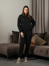 Ronin Black half-zip matching set for women, featuring a stand-neck sweatshirt and matching relaxed-fit trousers.