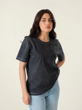 Model wearing Coastline's Sage Oversized Mineral Washed Tee in Black, featuring a loose fit, short sleeves and faded washed finish.