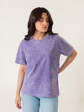 Model wearing Coastline's Sage Oversized Mineral Washed Tee in Purple, showing its relaxed fit, short sleeves and textured washed finish.
