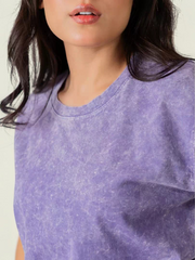 Close-up of the Sage Purple mineral-washed cotton t-shirt highlighting its crew neckline and faded, textured fabric.
