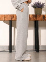 Angled view of the Soho Heather Grey trousers showing the relaxed wide-leg silhouette and fabric drape.