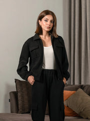 Close-up of the Varley Black collared zip-up jacket worn with matching cargo trousers