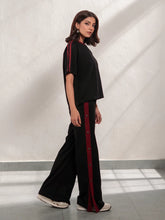 Zoey Black summer co-ord set for women with a relaxed short-sleeve top and wide-leg trousers featuring contrast red side stripes.
