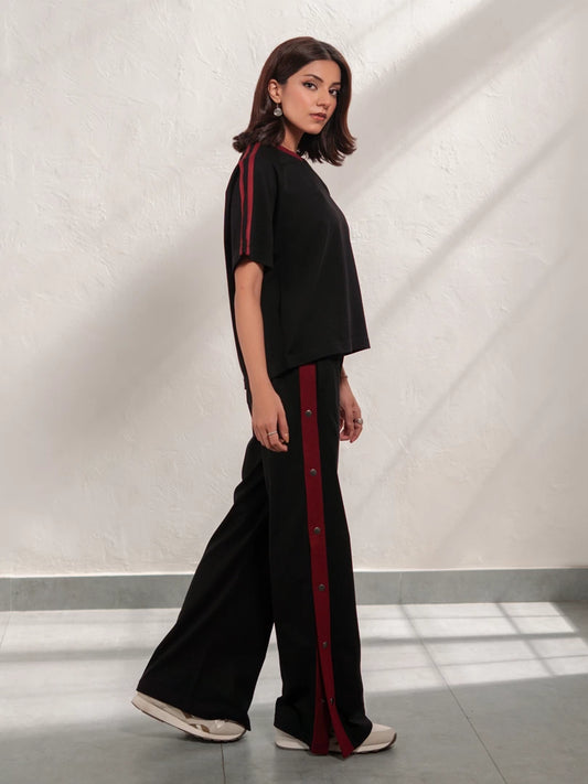 Zoey Black summer co-ord set for women with a relaxed short-sleeve top and wide-leg trousers featuring contrast red side stripes.