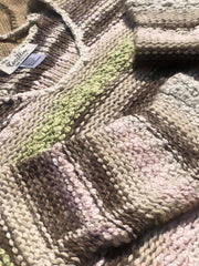 Close-up of the textured multicolor knit fabric and striped pattern of Coastline's Cropped Multicolor Sweater.