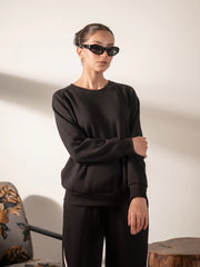 Full-length view of Lana Black winter matching set with sweatshirt and striped wide-leg trousers