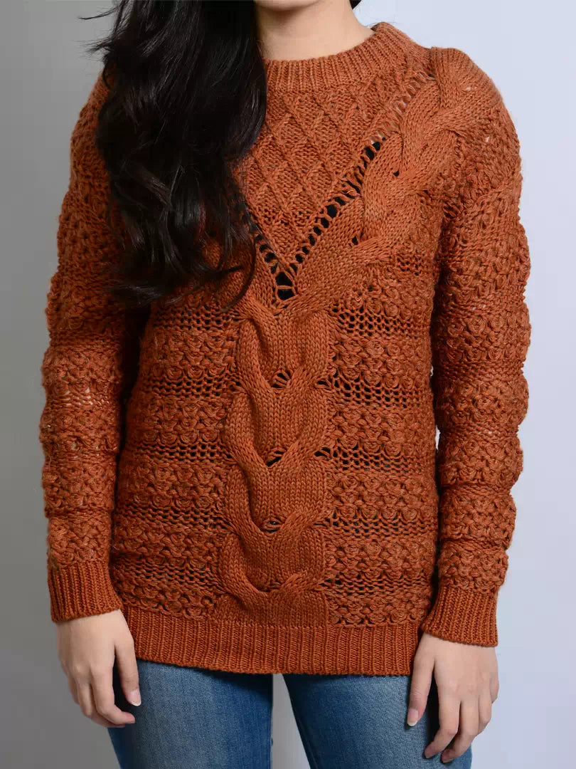 Person wearing a brown knitted sweater with a pattern on a plain background