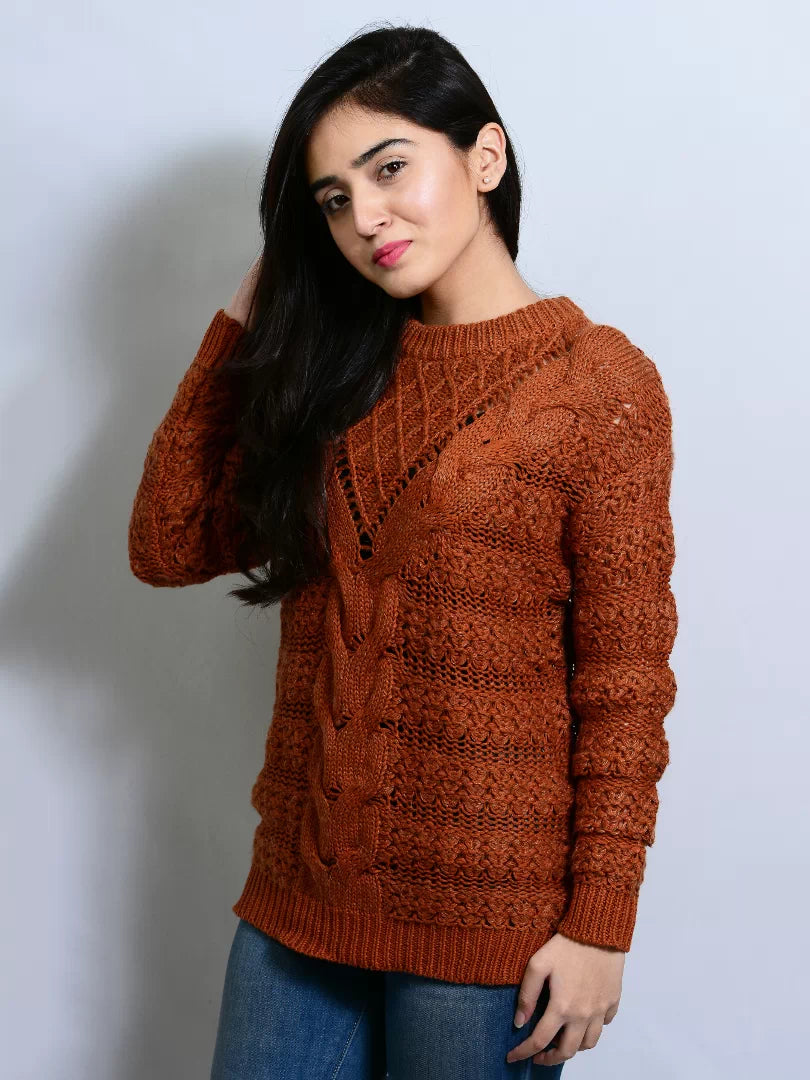 Woman wearing a brown knitted sweater against a plain background