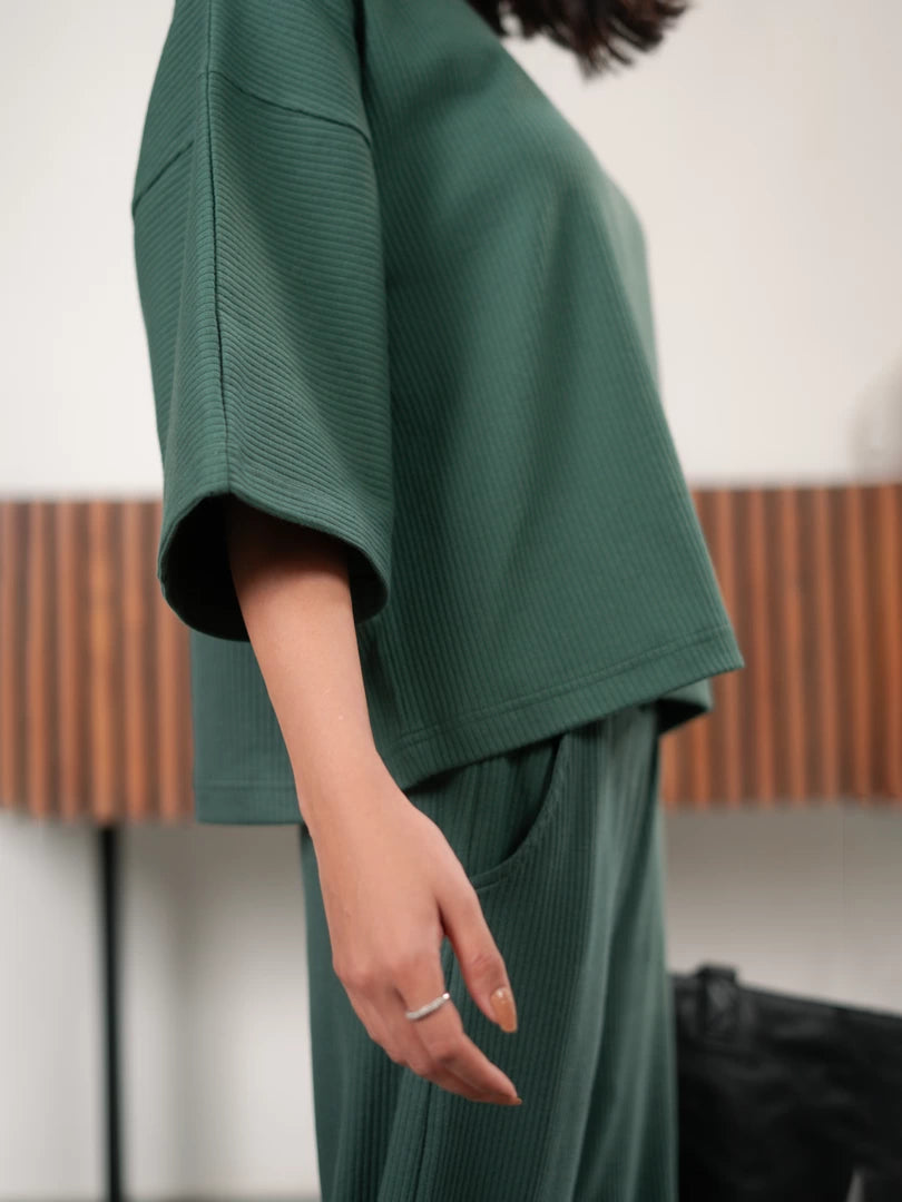Close-up of The Blair Evergreen double-knit top showing its relaxed sleeve and hem detailing