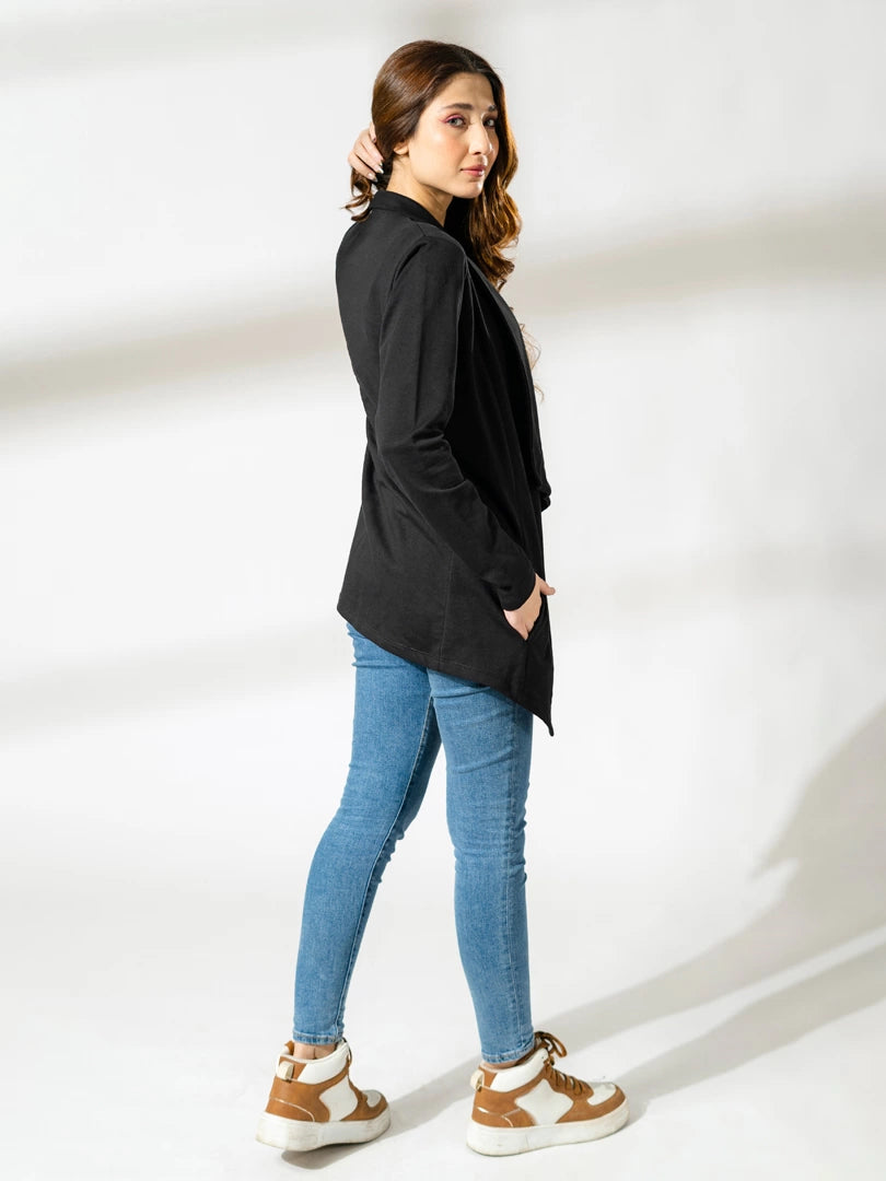 Full-length side view of the black Ash Front Open Overlayer styled with blue jeans and casual shoes.