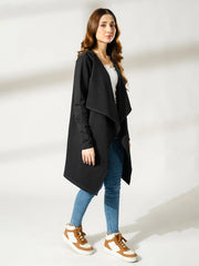 Full-length view of the Ashley black longline overlayer worn with a white top, blue jeans and sneakers.