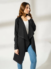 Angled view of the Ashley black open-front overlayer showing the draped front and long sleeves, with one hand near the face.