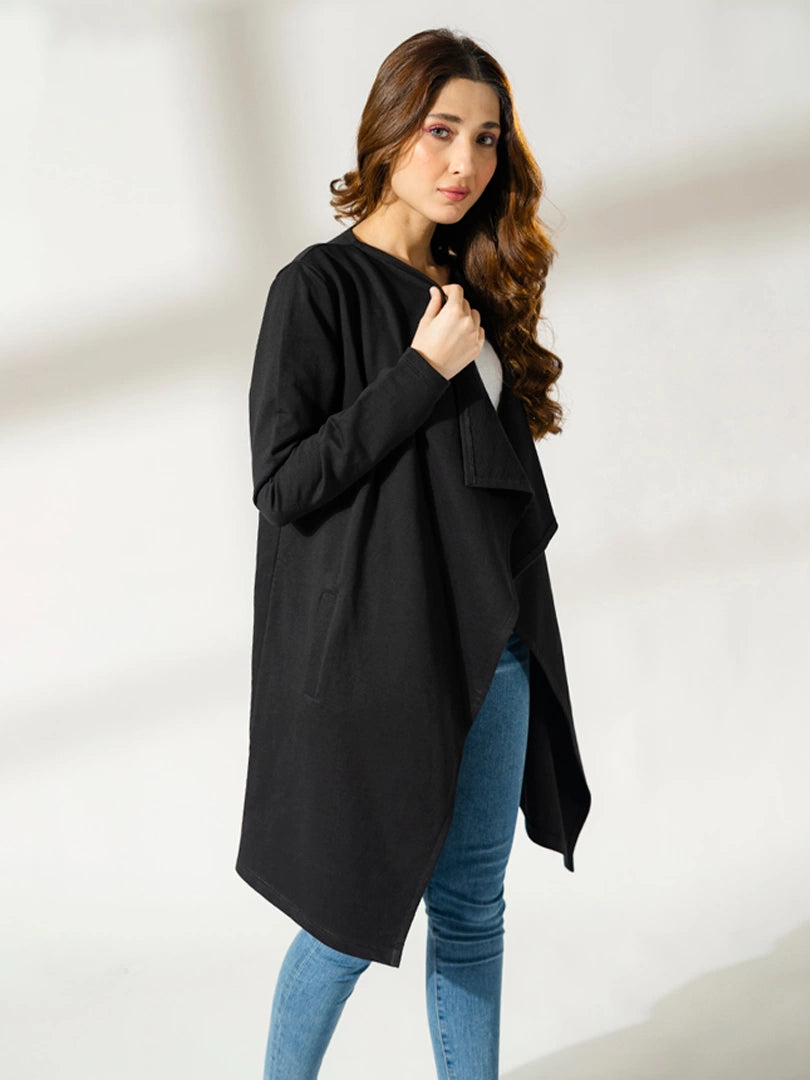 Closer view of the Ashley black overlayer showing the draped front, with the model holding the fabric near her shoulder.