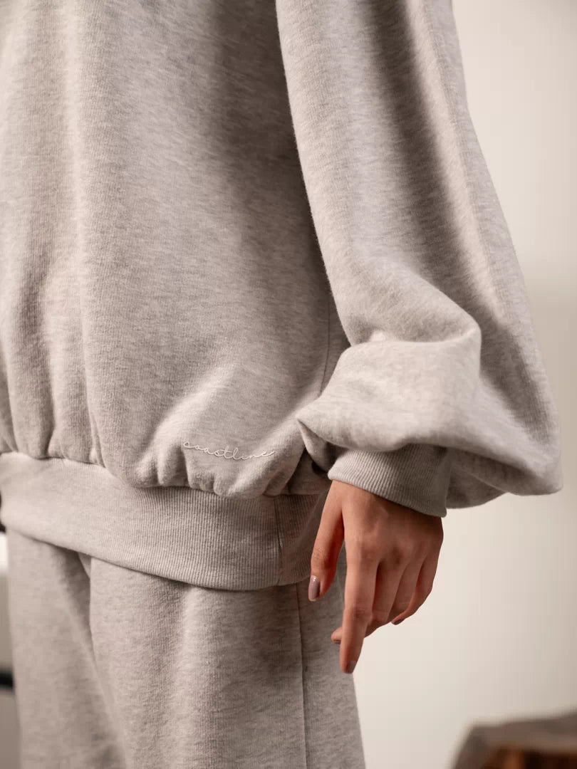 Close-up of the Barlow sweatshirt in Heather Grey showing its voluminous balloon sleeve gathered into a fitted ribbed cuff.