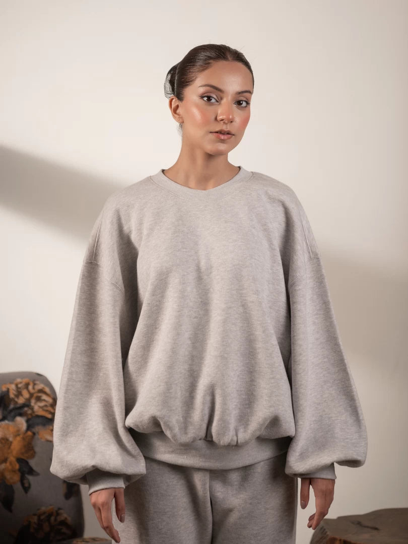 Straight-on view of the Barlow women's fleece sweatshirt in Heather Grey, featuring a crew neckline, balloon sleeves and gathered waist.