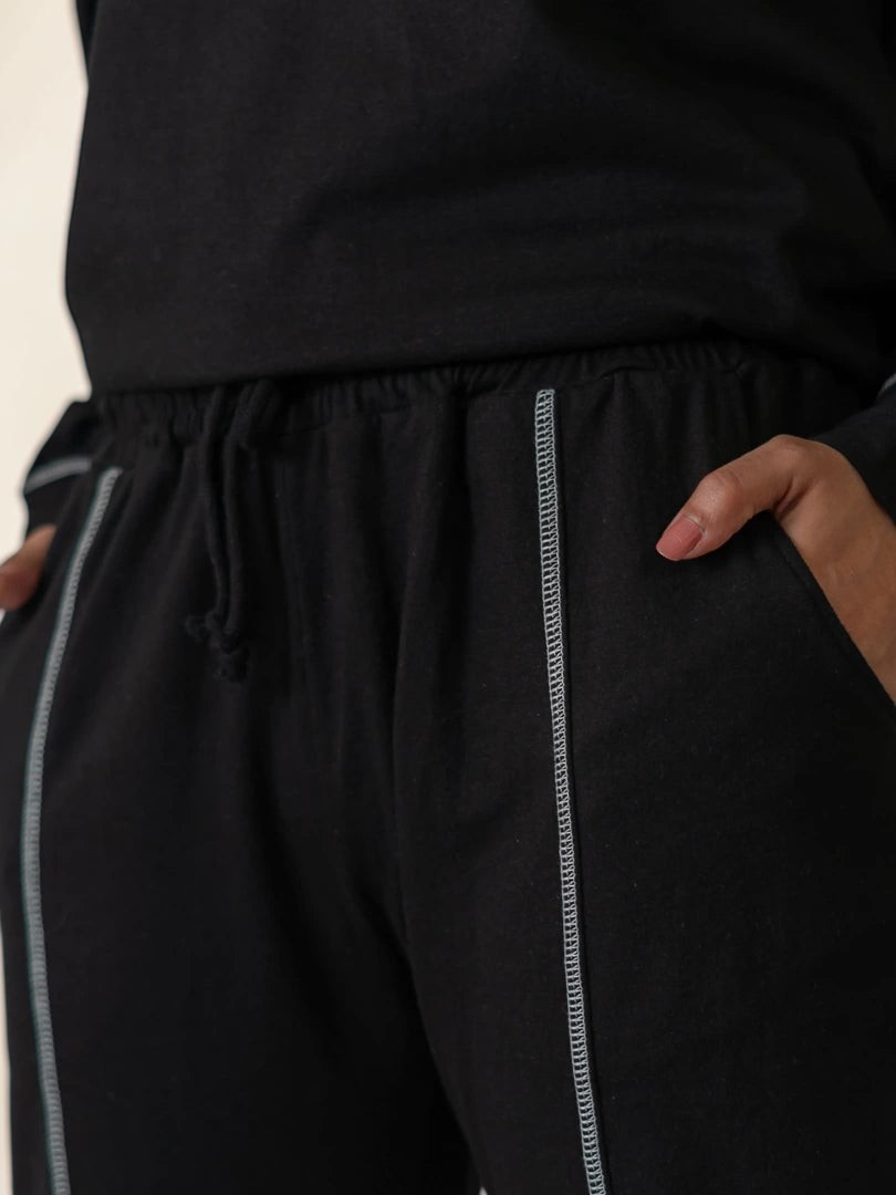 Close-up of the Berlin Black matching trousers showing the elasticated waistband, side pocket and contrast stitching.