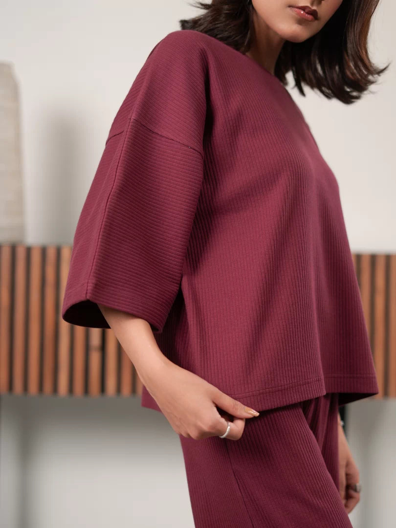 Closer view of The Blair Plum double-knit top showing the relaxed sleeves and draped silhouette