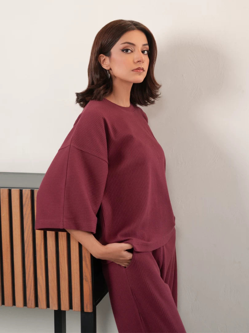 Three-quarter view of The Blair Plum co ord set with a relaxed top and matching wide-leg trousers
