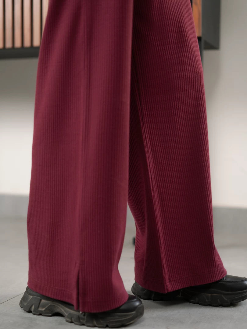 Close-up of The Blair Plum matching set trousers showing their flowing wide-leg fit and rich plum colour