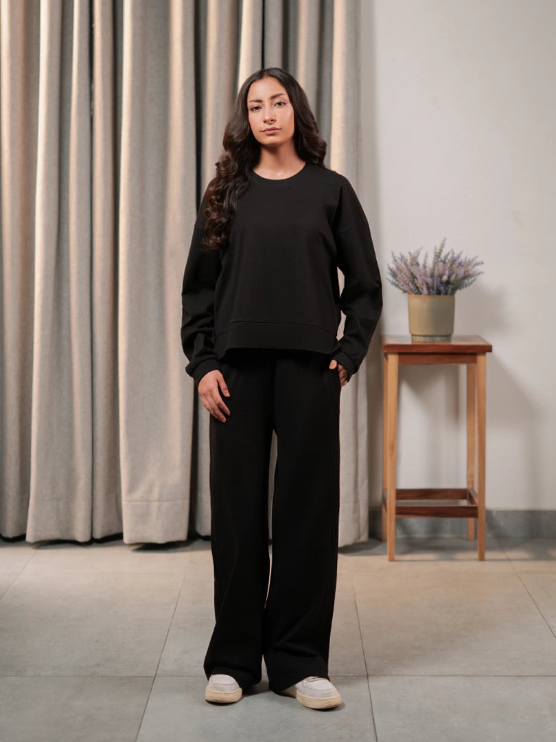 Front view of the Brooklyn black matching set showing the loose boxy top, long sleeves and wide-leg trousers.
