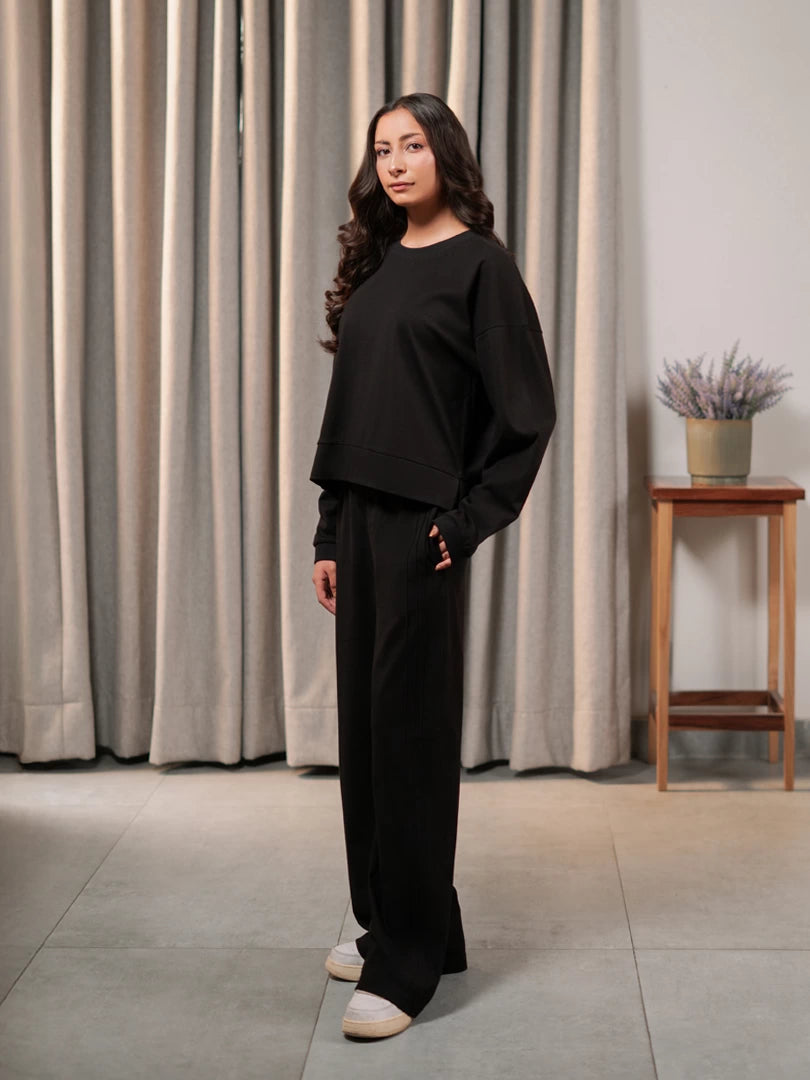 Angled view of the Brooklyn black co-ord set showing the boxy top and matching wide-leg trousers.