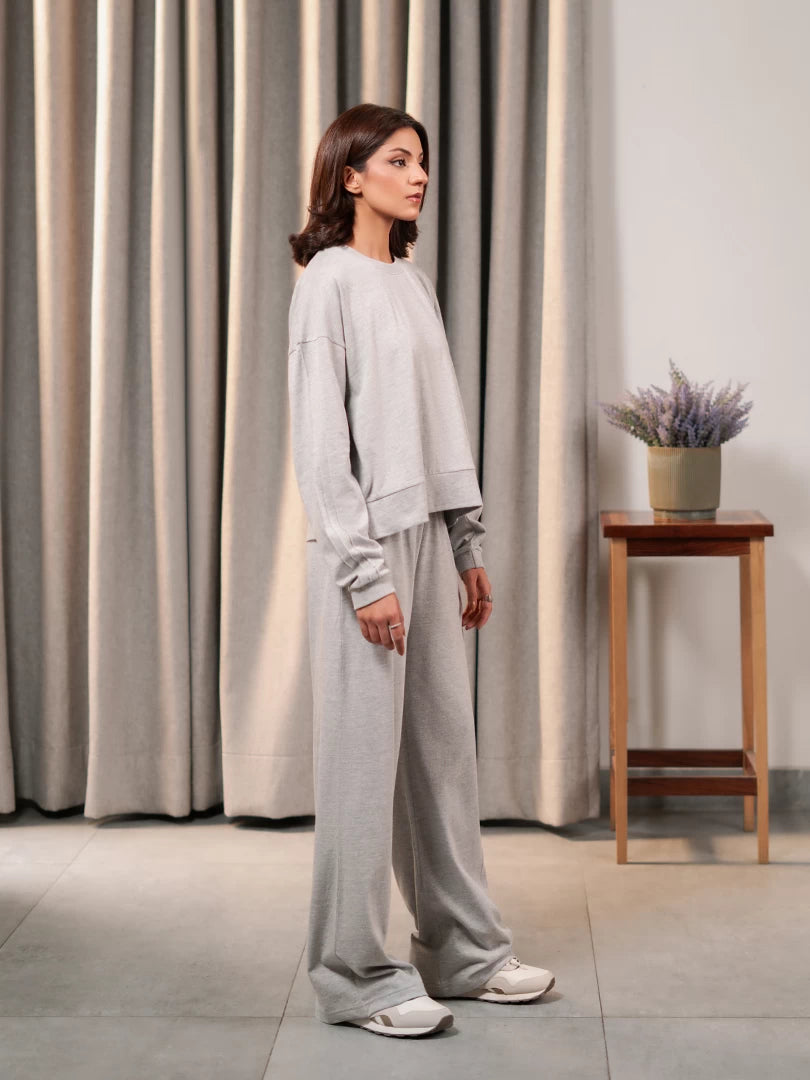 Side view of the Brooklyn Heather Grey matching set showing the boxy top and wide-leg trouser silhouette.