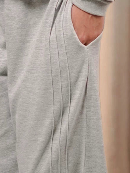Close-up of the Brooklyn Heather Grey matching set trousers, showing the wide-leg fabric drape and design detailing.