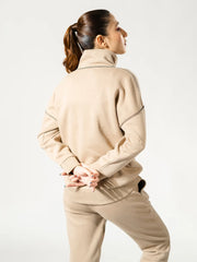 Back and side view of the Calca Natural Sand fleece matching set showing the relaxed sweatshirt silhouette