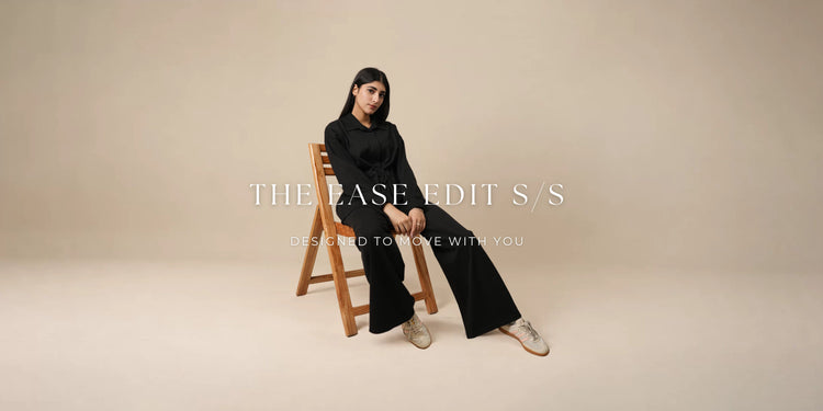Coastline The Ease Edit S/S — model wearing a black shirt and wide-leg trousers. Designed to move with you.