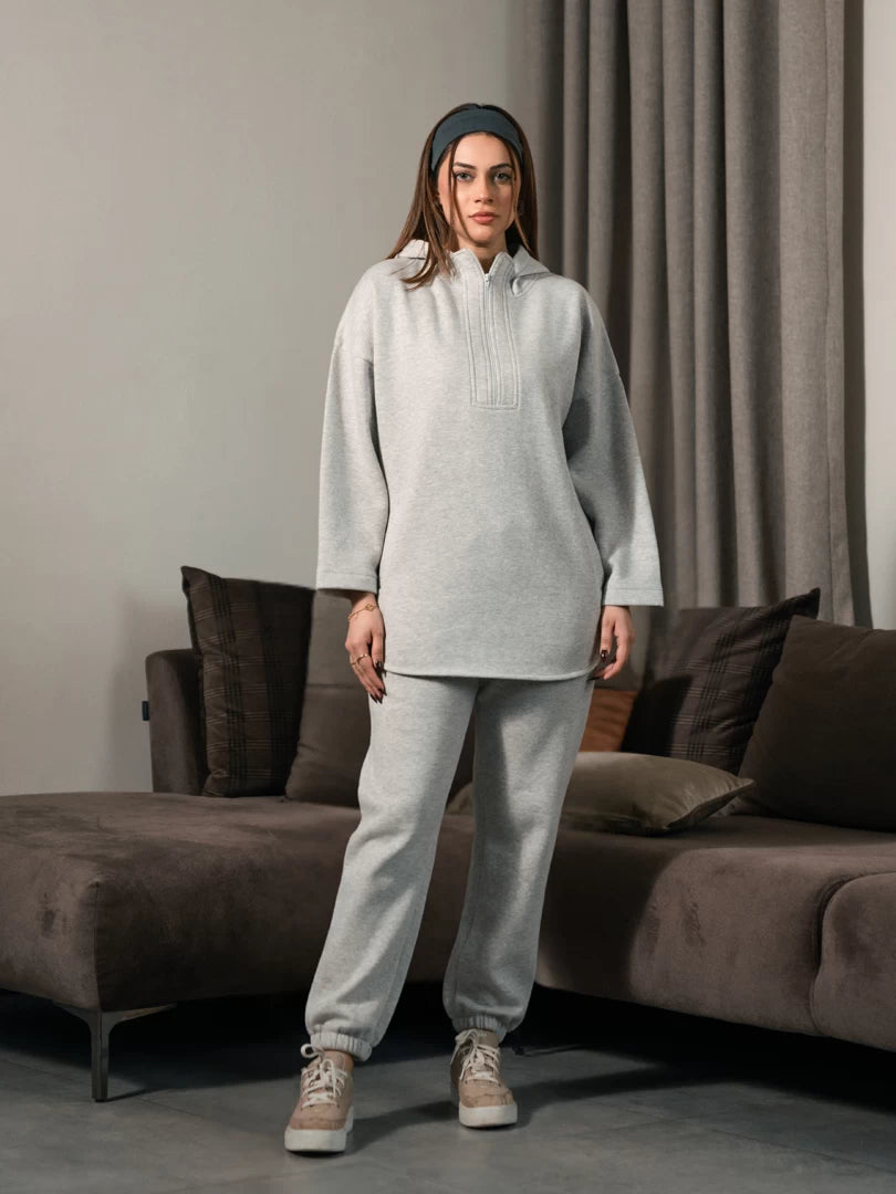 Front view of the Darya Heather Grey oversized hoodie set showing the long hoodie with a curved hem and matching trousers.