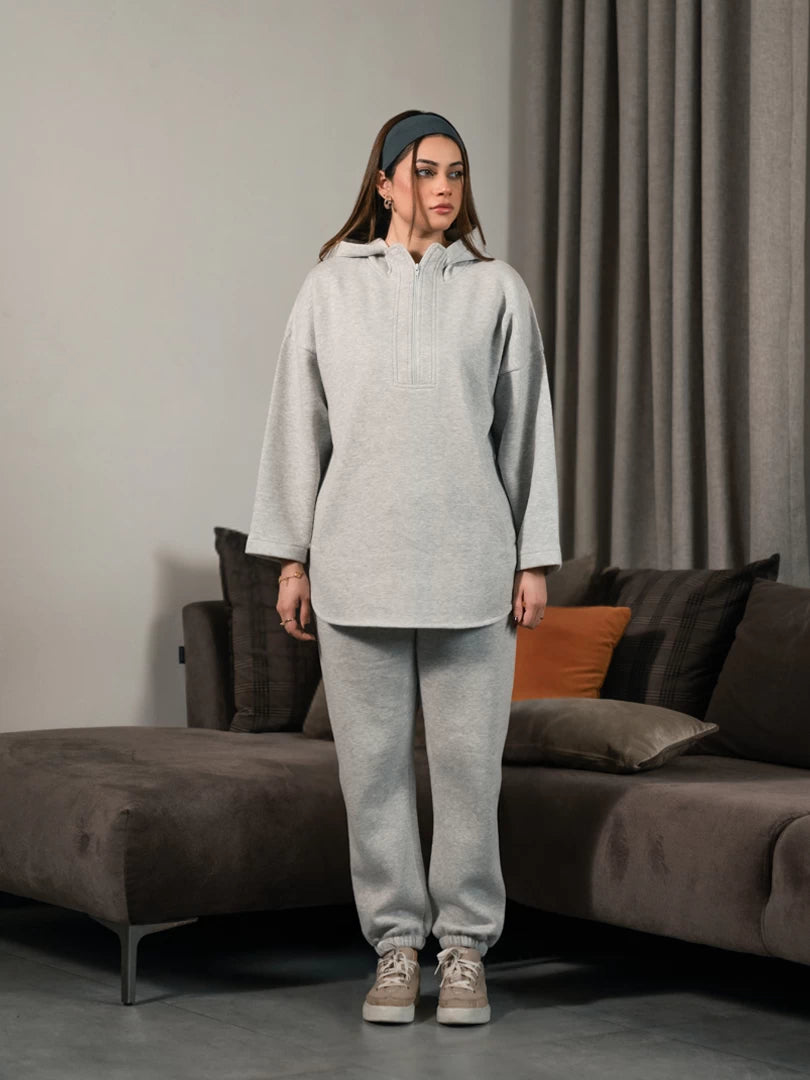 Full-length front view of the Darya Heather Grey winter co-ord set, with the model raising one hand near her hair.