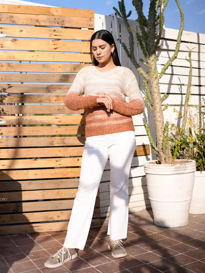 Model wearing Coastline's Dusty Tan Dip Dyed Sweater with folded arms, showing the sweater's front texture.